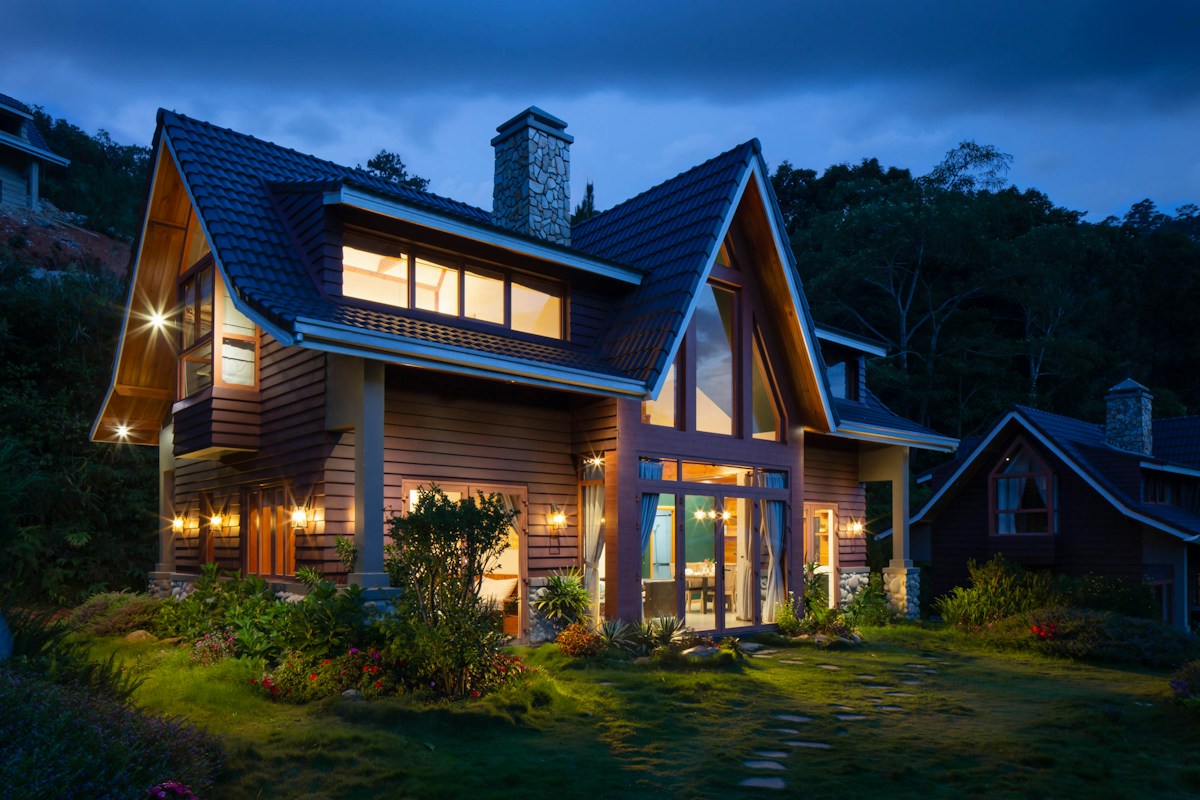 Warmly lit home with a stone chimney — stock inspiration photo